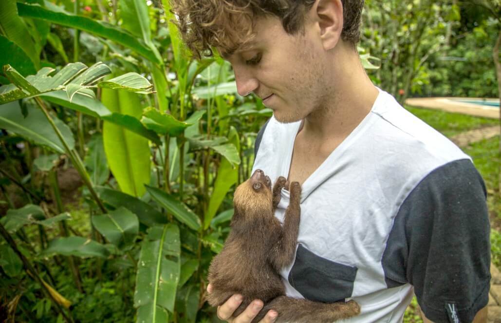 volunteer holding sloth costa rica